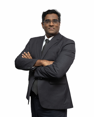 A partner of legal firm, Rajesh standing with a white background