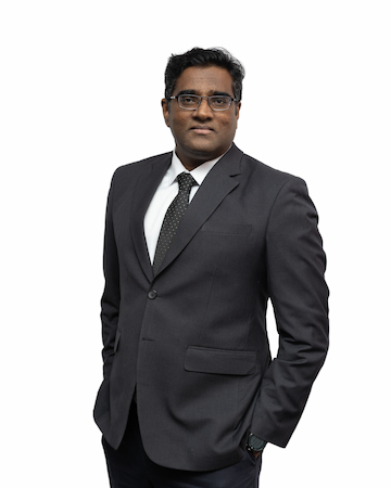 A photo of partner, Rajesh Nagarajan with a whote backdrop