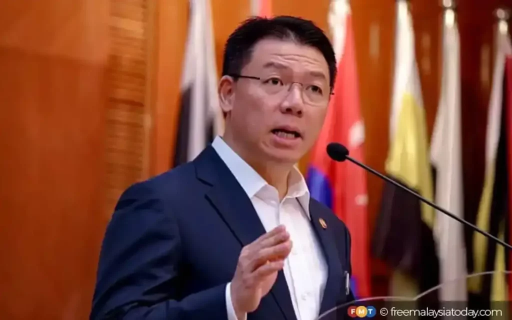 A photo of a minister name Nga Kor Ming giving an announcement